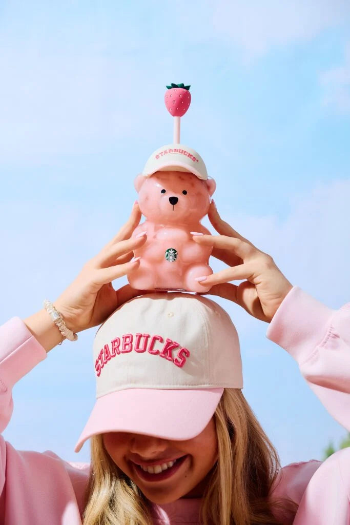 Pink bearista cup held up