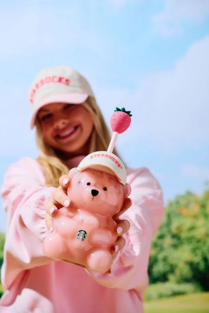 Girl smiling with bearista cup